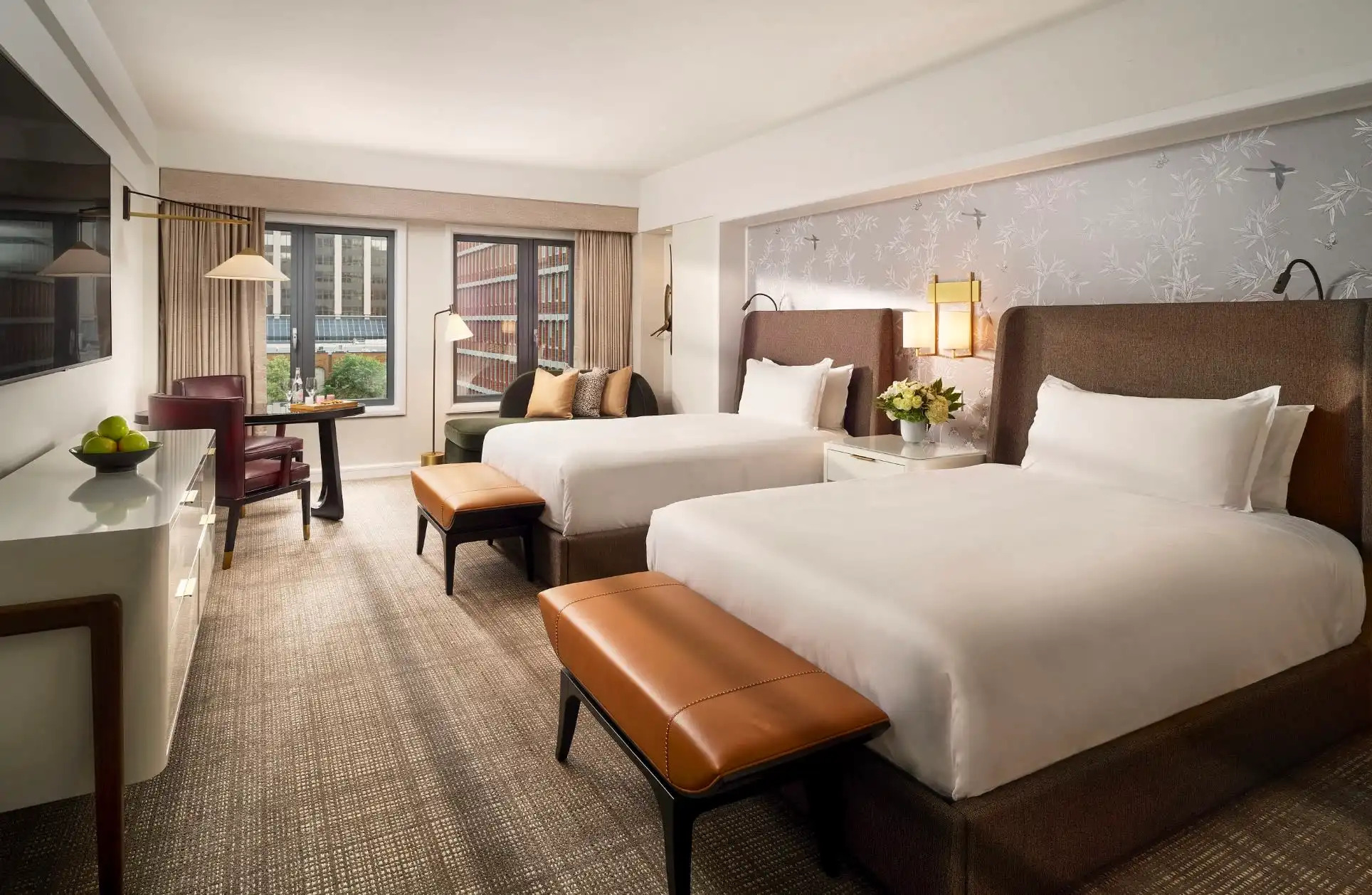 Hotel room with two double beds and sleek modern furnishings